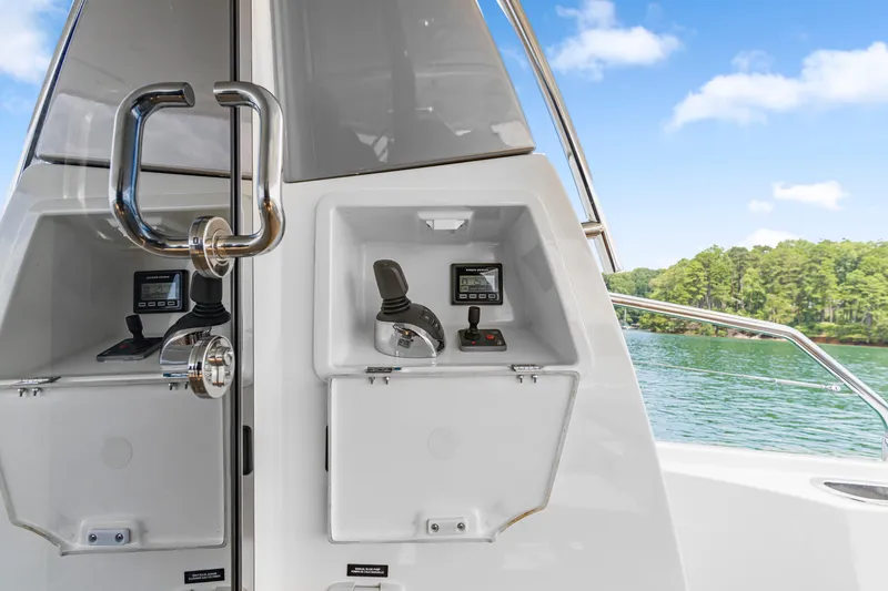 Slide: The Image of Control panel on a 2017 Prestige 500 yacht, overlooking serene waters and lush greenery. - 40