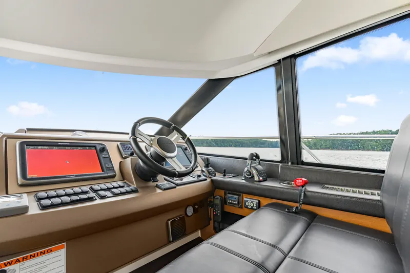 Slide: The Image of 2017 Prestige 500 yacht helm with modern navigation controls and panoramic view. - 46