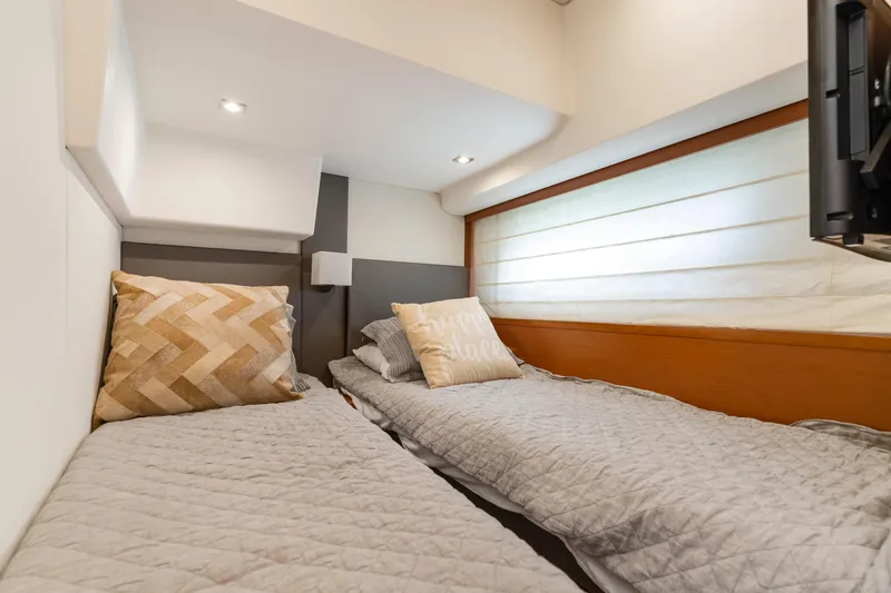 Slide: The Image of Luxurious twin cabin in 2017 Prestige 500 yacht, featuring cozy bedding and modern decor. - 9