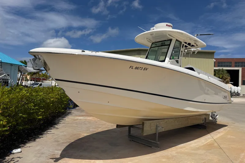Slide: The Image of 2019 Boston Whaler 280 Outrage boat on display under a clear blue sky. - 1