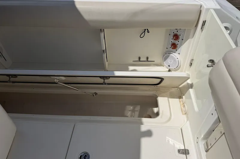 Slide: The Image of 2019 Boston Whaler 280 Outrage interior with storage compartments and speaker system. - 10
