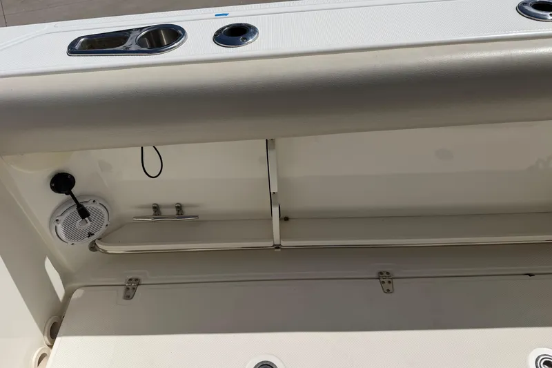 Slide: The Image of Interior view of a 2019 Boston Whaler 280 Outrage boat, featuring storage and speaker. - 12