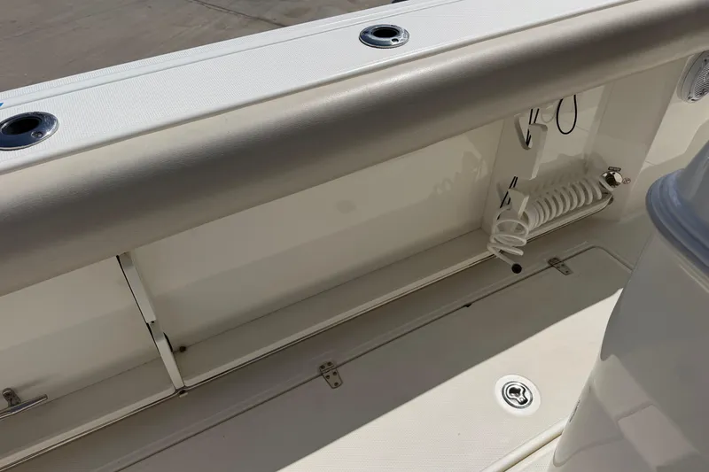Slide: The Image of 2019 Boston Whaler 280 Outrage boat interior detail with rod holders and storage compartments. - 13