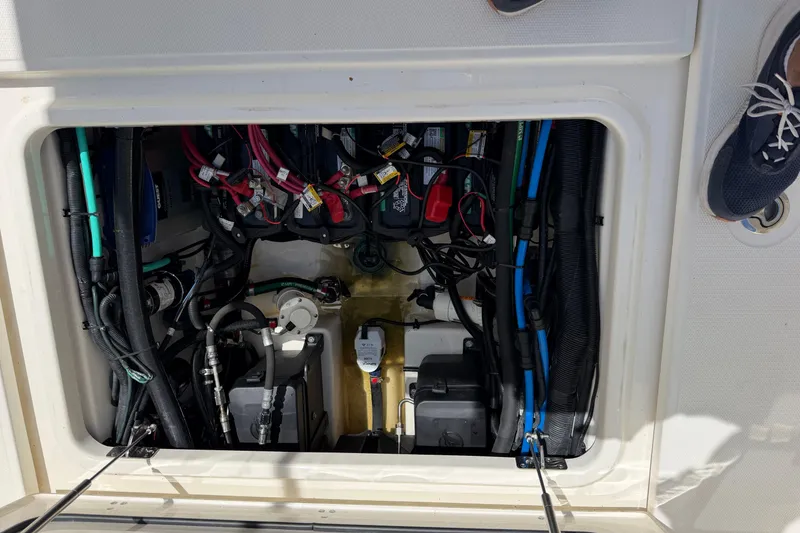 Slide: The Image of 2019 Boston Whaler 280 Outrage engine compartment with wiring and components visible. - 15