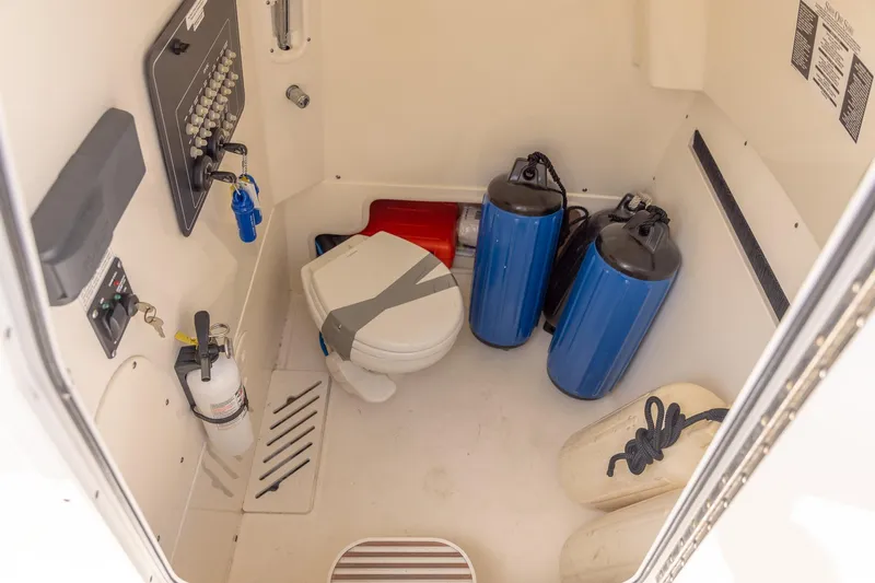 Slide: The Image of Interior of 2019 Boston Whaler 280 Outrage boat with toilet and safety equipment. - 15