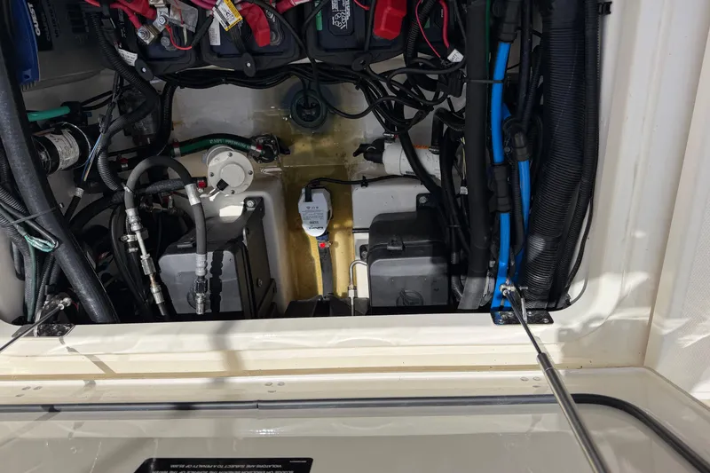 Slide: The Image of 2019 Boston Whaler 280 Outrage engine compartment with wiring and components visible. - 16