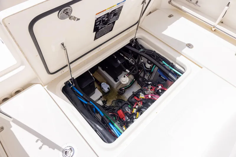 Slide: The Image of 2019 Boston Whaler 280 Outrage engine compartment with wiring and components visible. - 36
