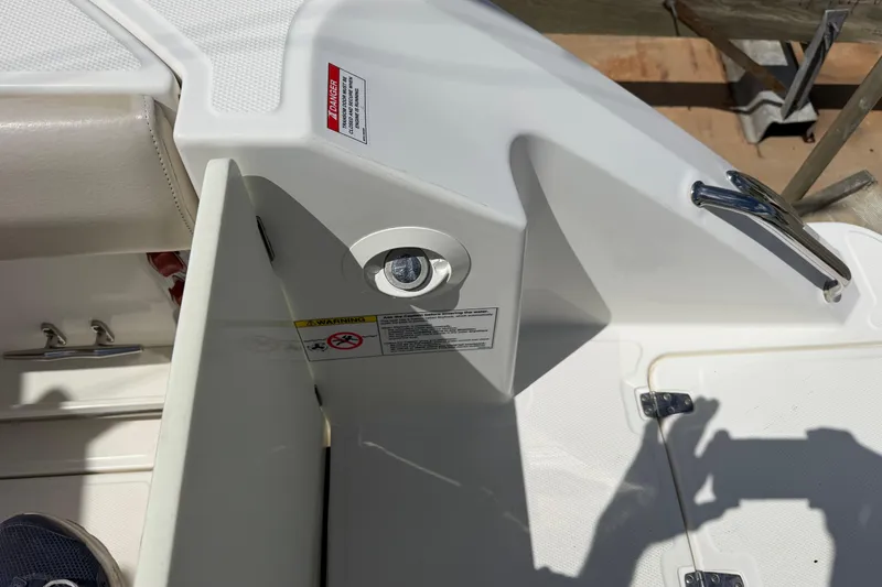 Slide: The Image of 2019 Boston Whaler 280 Outrage boat interior detail with warning labels and hardware. - 20