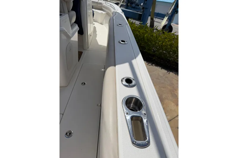 Slide: The Image of 2019 Boston Whaler 280 Outrage boat deck with rod holders and seating area. - 21