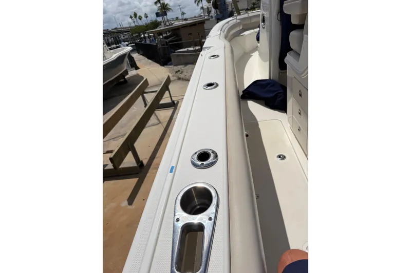 Slide: The Image of 2019 Boston Whaler 280 Outrage boat deck with rod holders and storage compartments. - 23