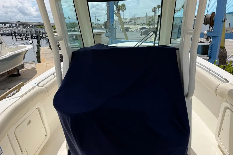 Slide: The Image of 2019 Boston Whaler 280 Outrage boat interior with covered console at marina. - 25