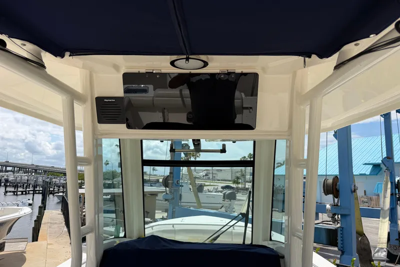 Slide: The Image of 2019 Boston Whaler 280 Outrage interior view with marina background. - 26