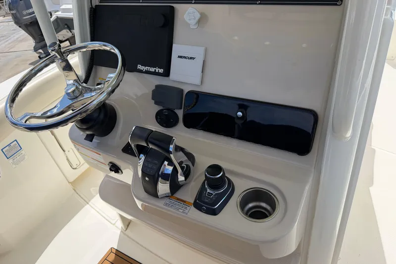 Slide: The Image of 2019 Boston Whaler 280 Outrage helm with steering wheel and control panel. - 28