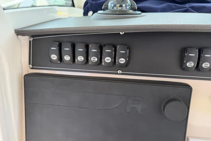 Slide: The Image of Control panel of a 2019 Boston Whaler 280 Outrage boat with labeled switches. - 32
