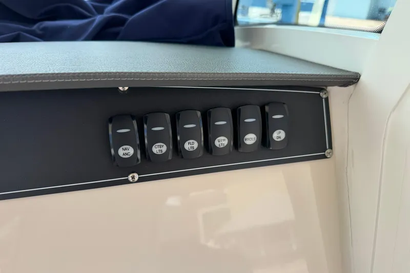 Slide: The Image of Control panel of a 2019 Boston Whaler 280 Outrage boat with labeled switches. - 34