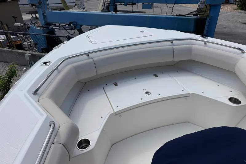 Slide: The Image of 2019 Boston Whaler 280 Outrage boat interior with cushioned seating and stainless steel railings. - 37