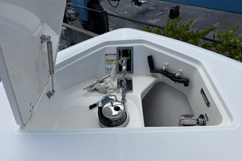 Slide: The Image of Anchor compartment of 2019 Boston Whaler 280 Outrage boat, featuring chain and winch. - 41
