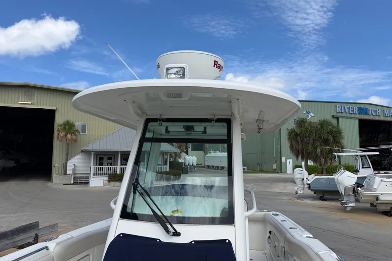 Slide: The Image of 2019 Boston Whaler 280 Outrage at marina, showcasing helm and radar equipment. - 43