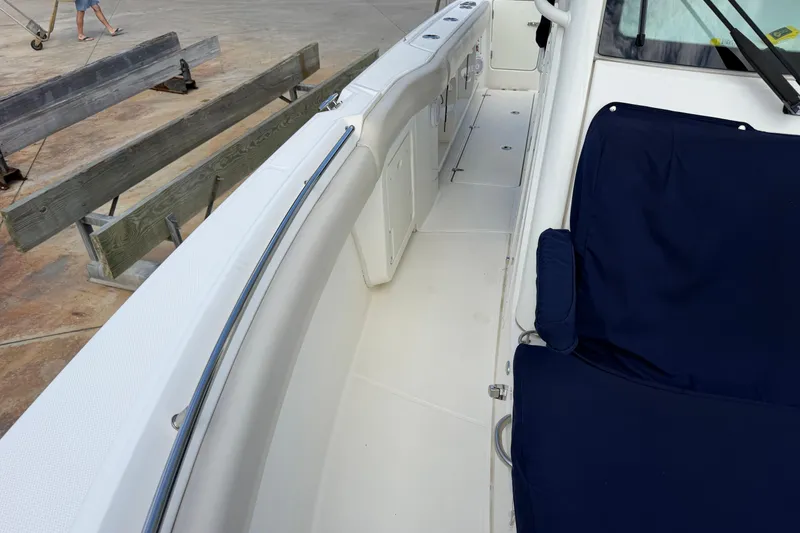 Slide: The Image of 2019 Boston Whaler 280 Outrage boat interior with blue seating and white deck. - 45