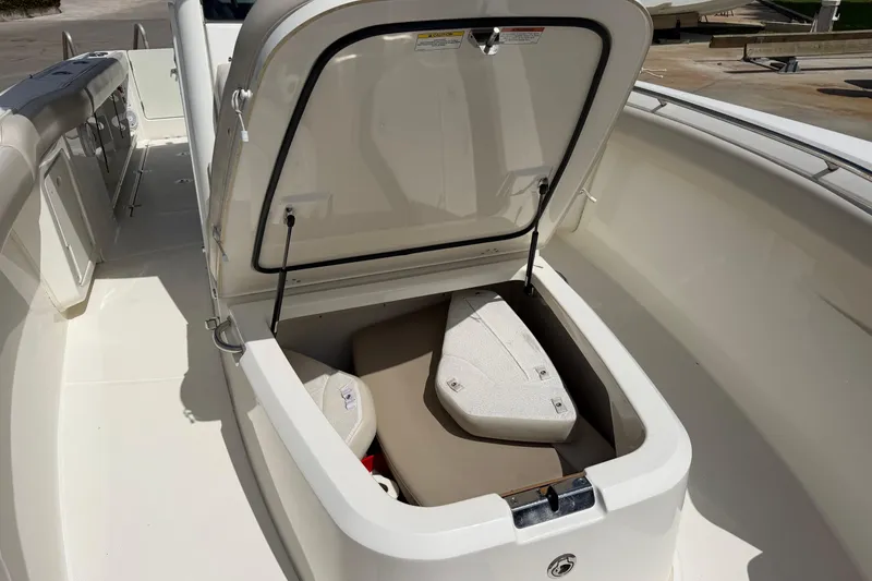 Slide: The Image of 2019 Boston Whaler 280 Outrage boat storage compartment open, showcasing interior space. - 48