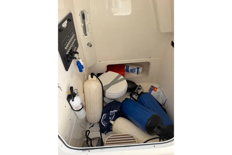 Slide: The Image of Interior of a 2019 Boston Whaler 280 Outrage boat with storage items and equipment. - 50