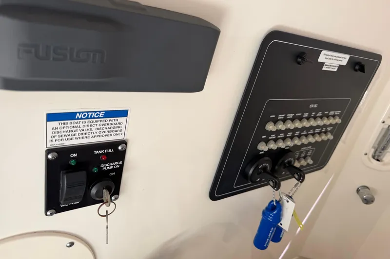 Slide: The Image of Control panel of a 2019 Boston Whaler 280 Outrage boat with keys and notice. - 51