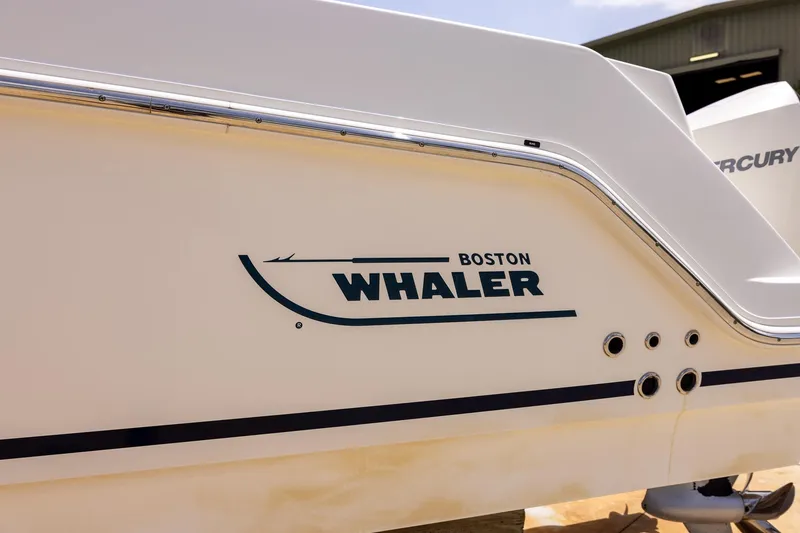 Slide: The Image of 2019 Boston Whaler 280 Outrage boat side view with logo and Mercury engine. - 39