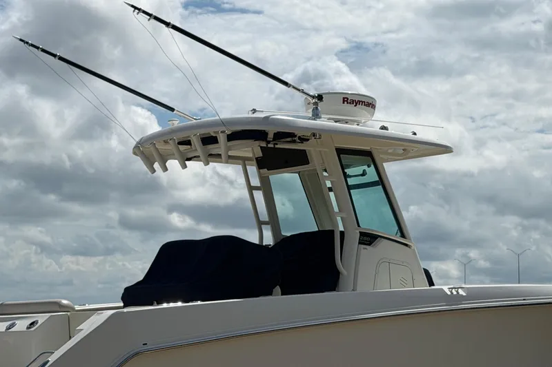 Slide: The Image of 2019 Boston Whaler 280 Outrage boat with radar and fishing rods against cloudy sky. - 56