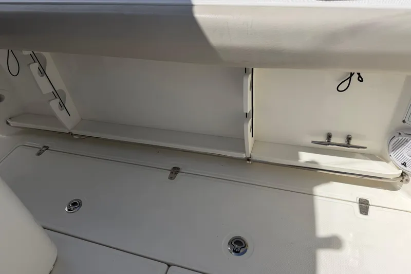 Slide: The Image of 2019 Boston Whaler 280 Outrage interior storage compartment with clean, white finish. - 7
