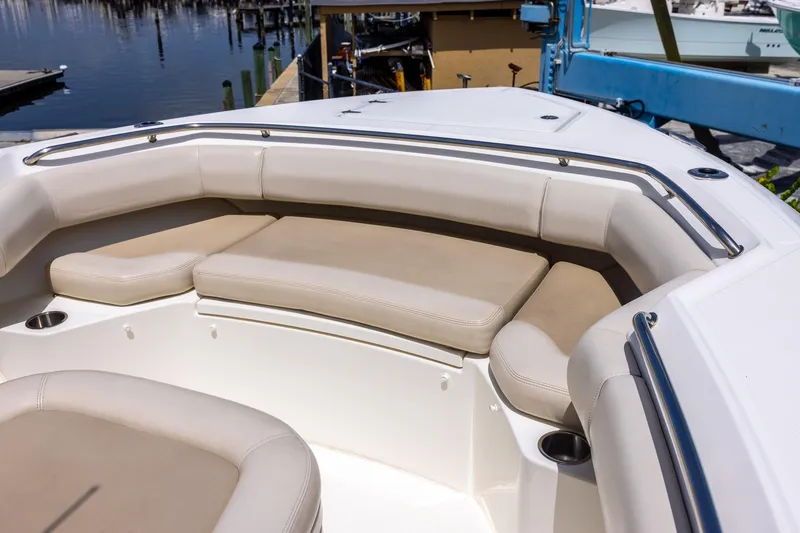 Slide: The Image of 2019 Boston Whaler 280 Outrage boat interior with cushioned seating and stainless steel railings. - 30