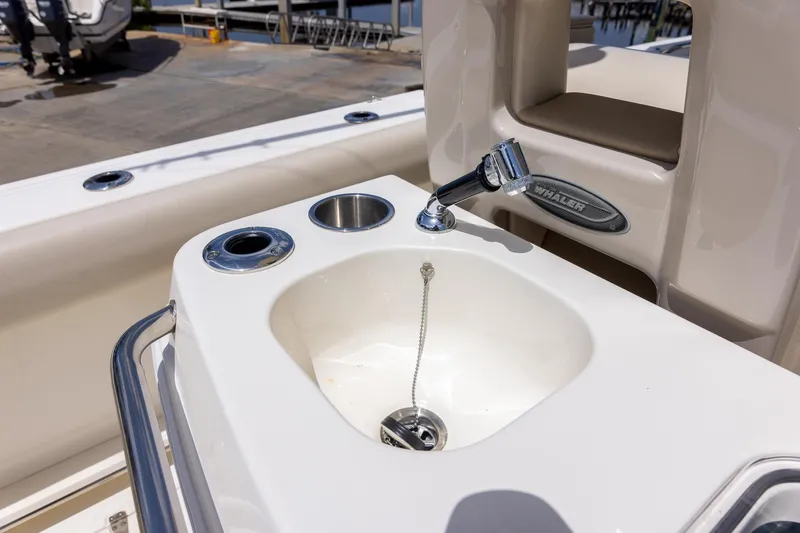 Slide: The Image of Boston Whaler 280 Outrage 2019 boat sink with faucet and cup holders. - 18