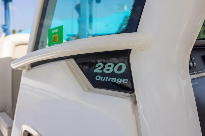 Slide: The Image of Close-up of 2019 Boston Whaler 280 Outrage boat model name on hull. - 26