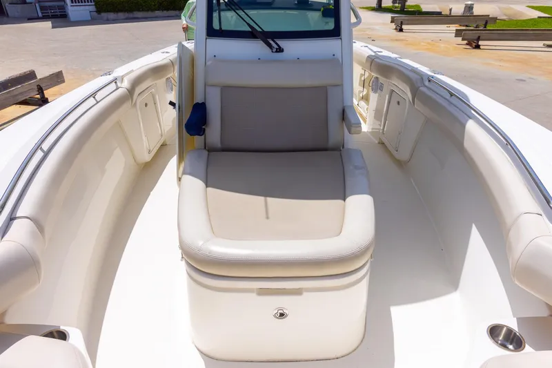 Slide: The Image of 2019 Boston Whaler 280 Outrage boat interior with cushioned seating and storage. - 28