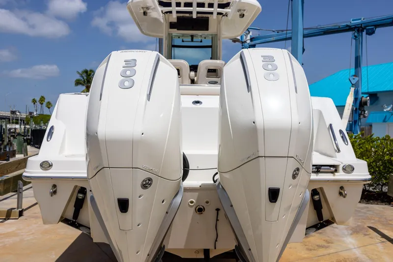 Slide: The Image of 2019 Boston Whaler 280 Outrage with twin 300 horsepower engines, docked under blue sky. - 40