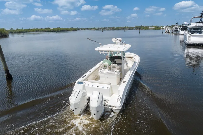 Slide: The Image of 2019 Boston Whaler 280 Outrage cruising on a calm river under a blue sky. - 5