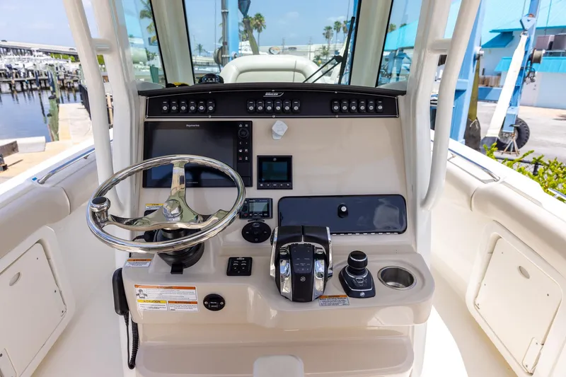 Slide: The Image of 2019 Boston Whaler 280 Outrage helm with steering wheel and control panel. - 10
