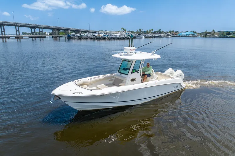 Slide: The Image of 2019 Boston Whaler 280 Outrage cruising on calm waters near a bridge. - 0