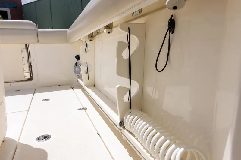 Slide: The Image of Interior view of 2019 Boston Whaler 280 Outrage boat, showcasing storage and seating area. - 24
