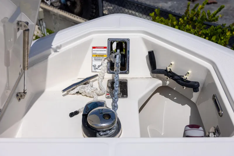 Slide: The Image of Anchor compartment of 2019 Boston Whaler 280 Outrage, featuring chain and cleat. - 33