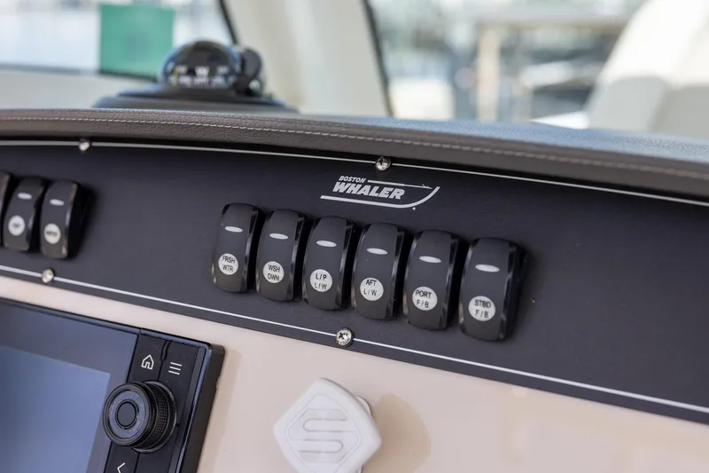 Slide: The Image of Control panel of a 2019 Boston Whaler 280 Outrage boat with labeled switches. - 13
