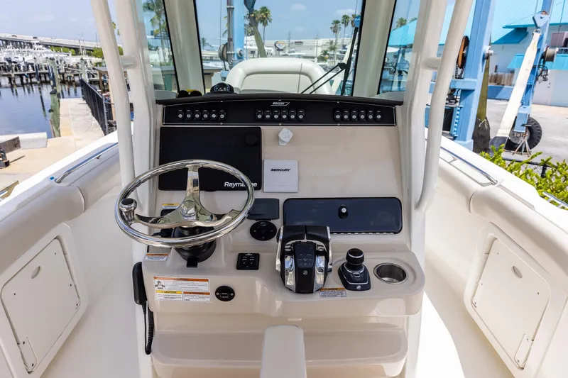 Slide: The Image of 2019 Boston Whaler 280 Outrage helm with steering wheel and control panel. - 8