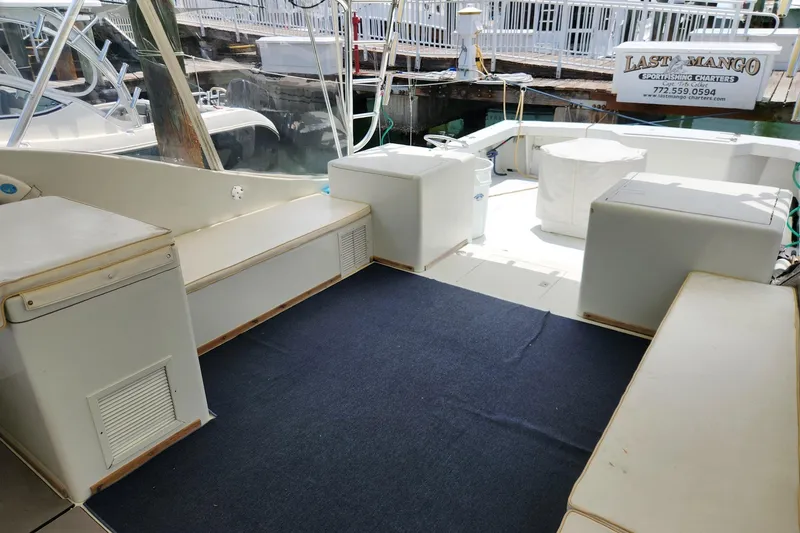 Slide: The Image of 1987 Young Brothers Custom Sport Fish boat interior with seating and fishing equipment. - 11