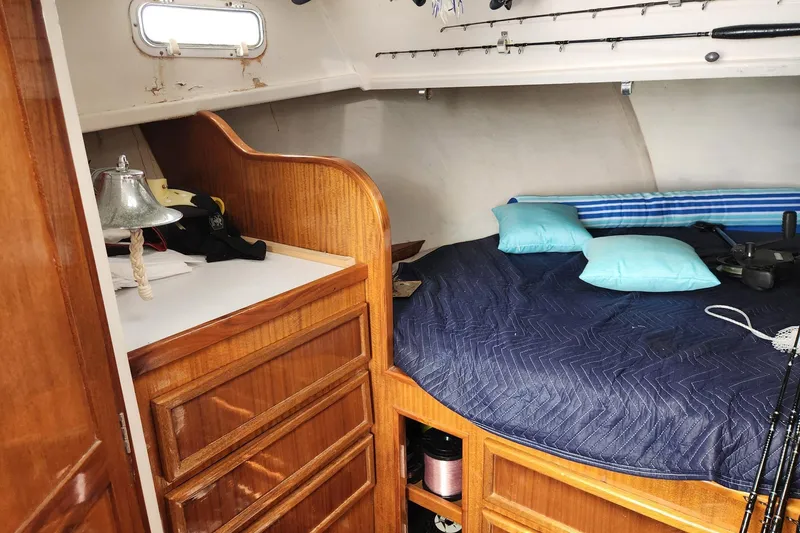 Slide: The Image of Cozy cabin interior of 1987 Young Brothers Custom Sport Fish boat with wooden cabinetry. - 15