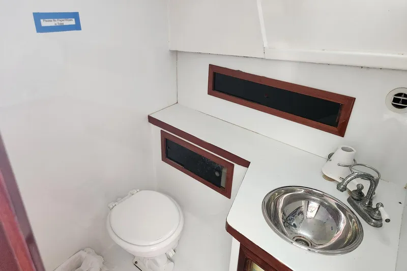 Slide: The Image of 1987 Young Brothers Custom Sport Fish boat bathroom with sink and toilet. - 18