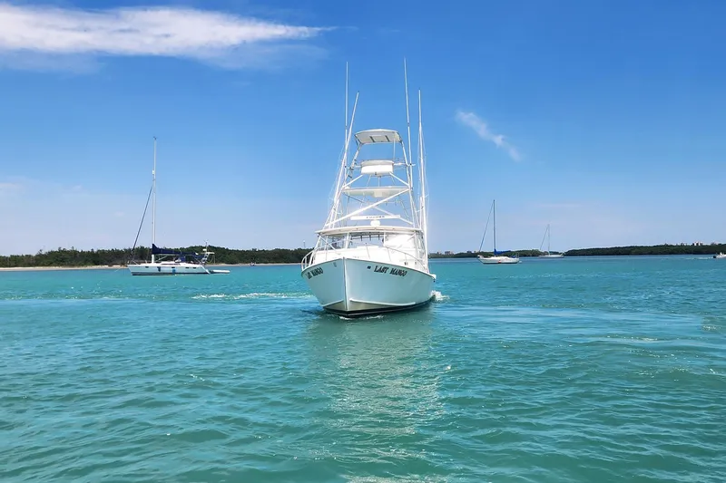 Slide: The Image of 1987 Young Brothers Custom Sport Fish boat cruising on clear blue water. - 2