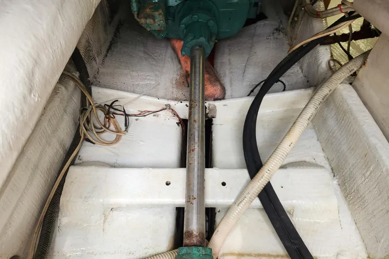 Slide: The Image of Engine compartment of 1987 Young Brothers Custom Sport Fish boat, showing shaft and wiring. - 23