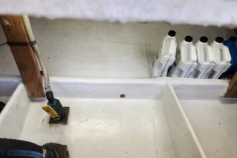 Slide: The Image of Bilge area of 1987 Young Brothers Custom Sport Fish with oil containers. - 24