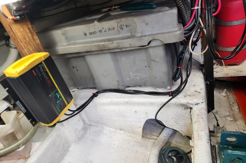 Slide: The Image of Battery compartment of 1987 Young Brothers Custom Sport Fish with ProSport HD2 charger. - 26