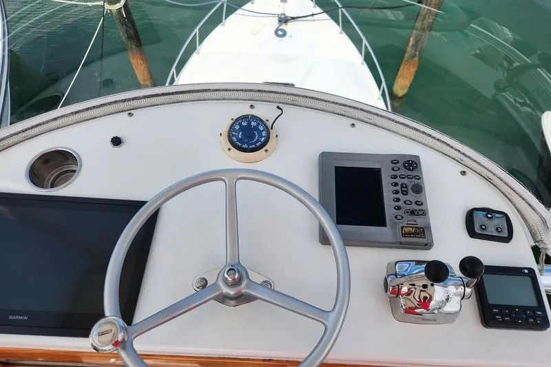 Slide: The Image of 1987 Young Brothers Custom Sport Fish helm with navigation instruments and steering wheel. - 27