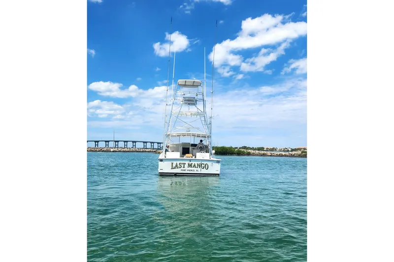 Slide: The Image of 1987 Young Brothers Custom Sport Fish boat on water under blue sky. - 3